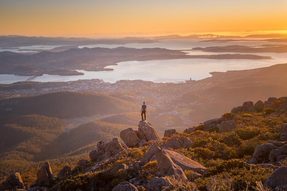 Mt Wellington man on rock sunr